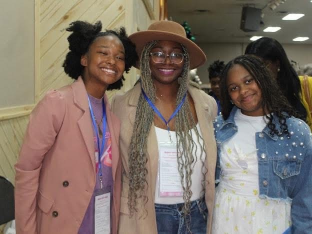 2025 Becoming Project — three young women smiling together
